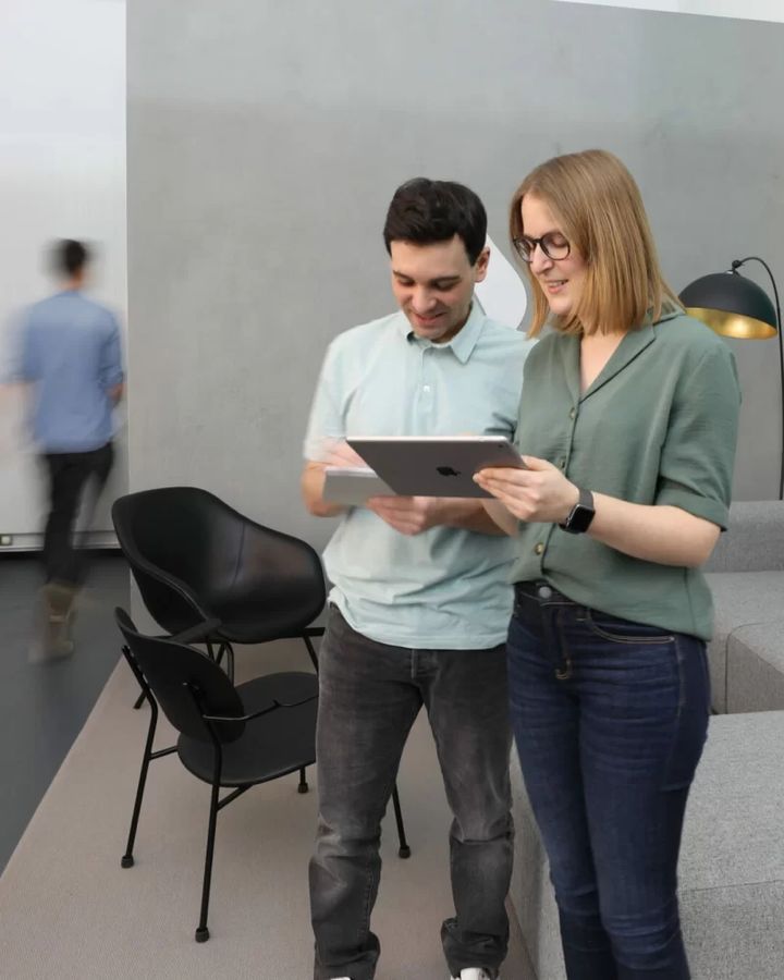 Zwei Kollegen schauen gemeinsam auf ein Tablet